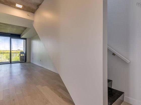 The entry as photographed: an open staircase with a wall-mounted handrail on the right.