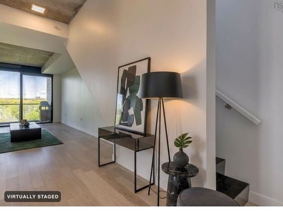The verified staged render: furniture and art added, staircase and railing untouched.