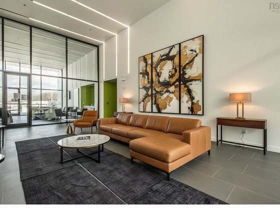 The staged render: the reception desk is gone, replaced with a sofa and open floor.