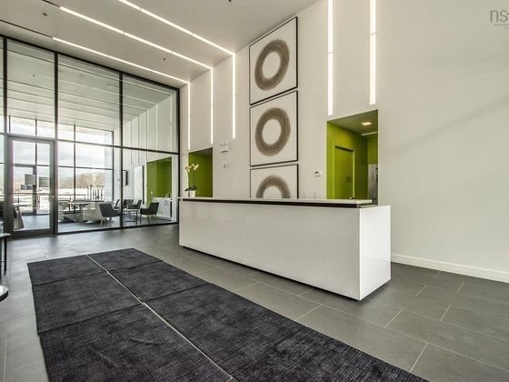 The lobby as photographed: a large white built-in reception desk dominates the centre.