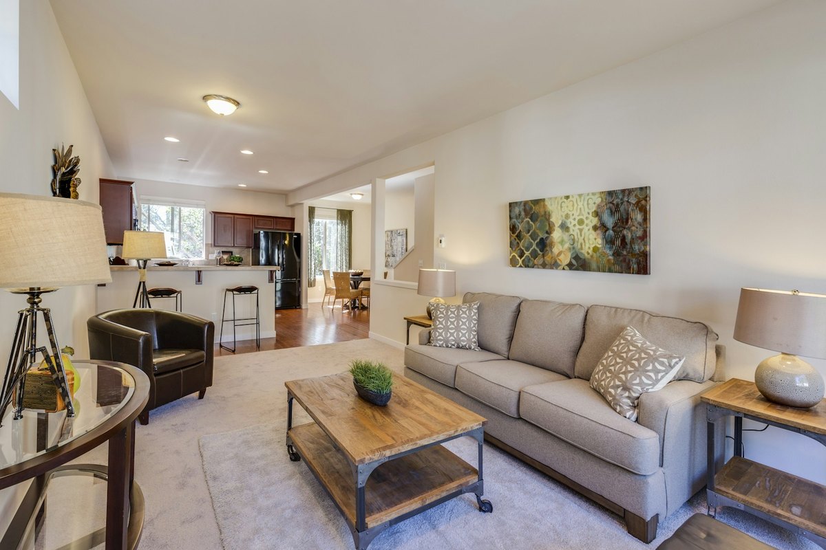 A furnished living room as photographed, sparsely styled